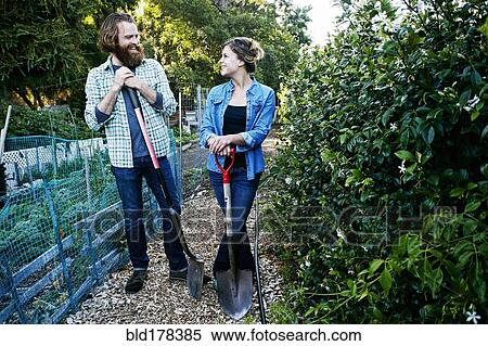 Stock Photography - Couple working together in garden. Fotosearch