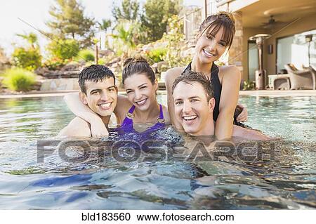 Couples smiling in swimming pool View Large Photo Image Stock Image - Couples smiling in swimming pool. Fotosearch