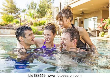 Couples talking in swimming pool View Large Photo Image Stock Photo - Couples talking in swimming pool. Fotosearch