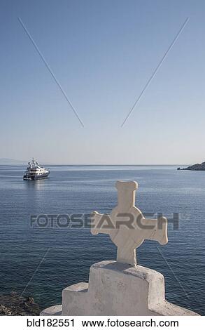Stock Image - Cross on traditional arch and seascape. Fotosearch