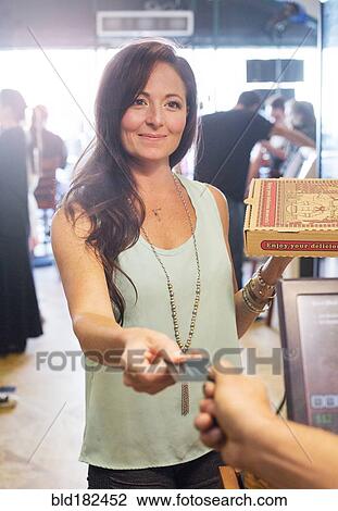 Stock Image - Customer purchasing pizza in cafe. Fotosearch