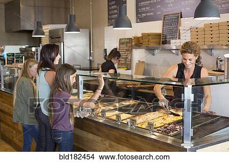 Picture - Customers choosing pizza in cafe. Fotosearch