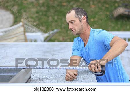 Deaf Caucasian roofer measuring skylight on roof View Large Photo Image Stock Photo - Deaf Caucasian roofer measuring skylight on roof. Fotosearch