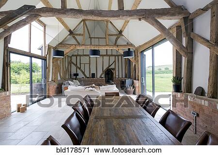Stock Image - Dining table and sofa in modern living space. Fotosearch
