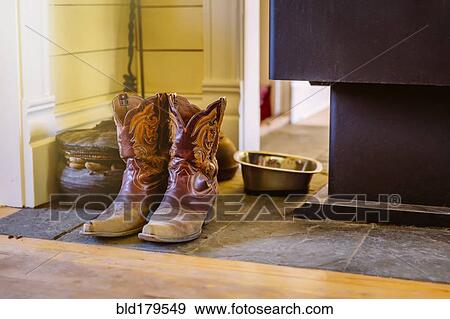 Stock Photo - Dirty boots on stone tile. Fotosearch