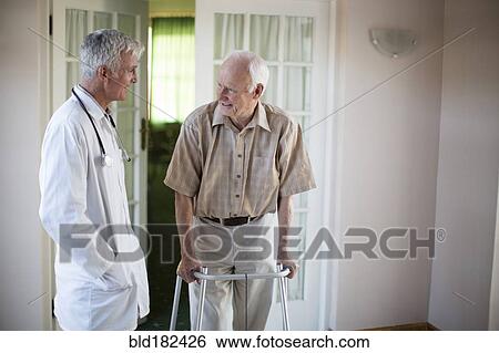 Doctor talking to patient using walker View Large Photo Image Stock Photograph - Doctor talking to patient using walker. Fotosearch