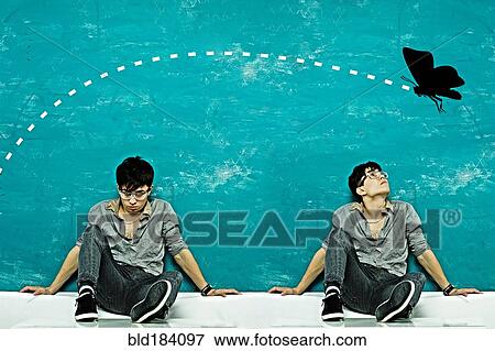 Stock Photo - Double exposure of Caucasian man under butterfly. Fotosearch