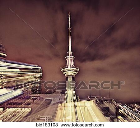 Stock Photo - Double exposure of cityscape and cloudy sky. Fotosearch