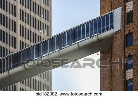Stock Image - Elevated walkway between highrise buildings. Fotosearch