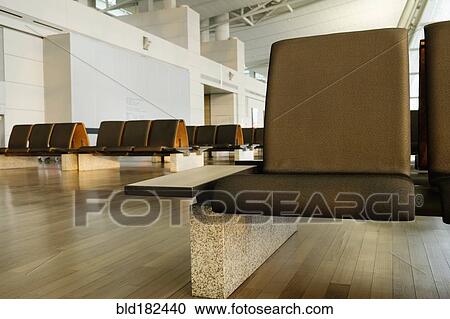 Stock Image - Empty chairs in airport waiting area. Fotosearch