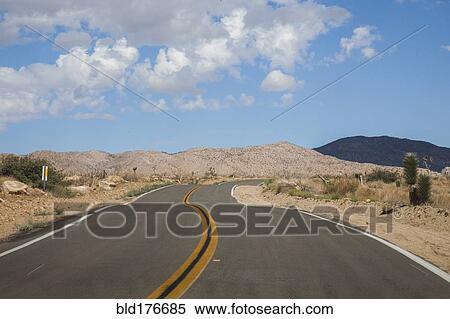 Stock Photography - Empty road in rural desert landscape. Fotosearch