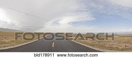Stock Image - Empty road in rural landscape. Fotosearch