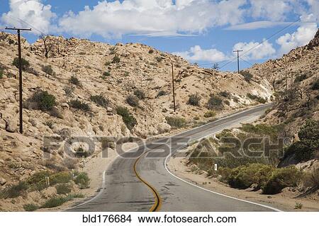 Picture - Empty road on rural desert hillside. Fotosearch