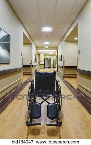 Stock Photo - Empty wheelchair in assisted living facility. Fotosearch