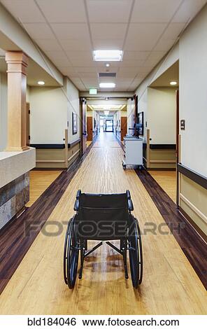Empty wheelchair in assisted living facility View Large Photo Image Stock Photograph - Empty wheelchair in assisted living facility. Fotosearch