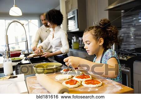 Stock Photograph - Family cooking in kitchen. Fotosearch