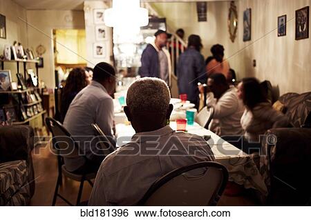 Family eating dinner at table View Large Photo Image Stock Photograph - Family eating dinner at table. Fotosearch