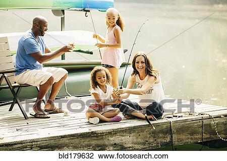Stock Image - Family fishing in lake. Fotosearch