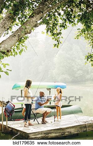 Stock Photography - Family fishing in lake. Fotosearch