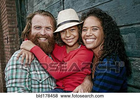 Stock Photo - Family hugging outdoors. Fotosearch