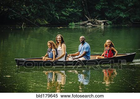 Family sitting in canoe in lake View Large Photo Image Stock Photography - Family sitting in canoe in lake. Fotosearch