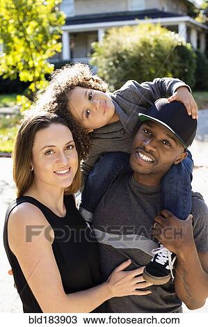 Stock Image - Family smiling outdoors. Fotosearch
