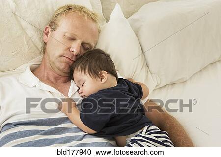 Father and baby son sleeping on bed View Large Photo Image Stock Image - Father and baby son sleeping on bed. Fotosearch
