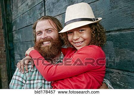 Stock Photo - Father and daughter hugging outdoors. Fotosearch