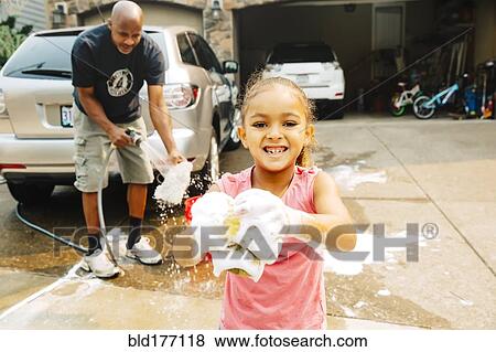 Stock Photo - Father and daughter washing car. Fotosearch