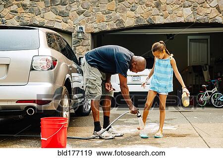Stock Photo - Father and daughter washing car. Fotosearch