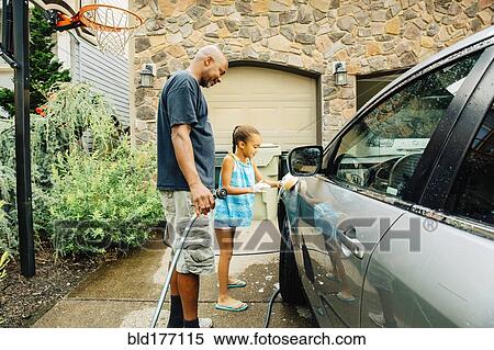 Stock Photography - Father and daughter washing car. Fotosearch