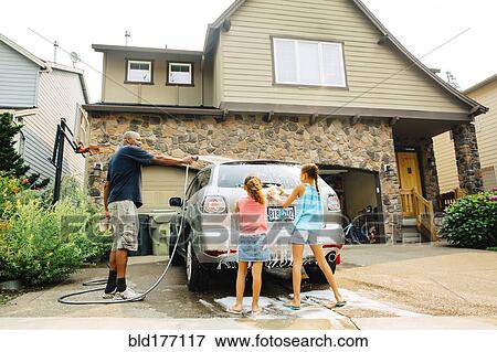Stock Photo - Father and daughters washing car. Fotosearch