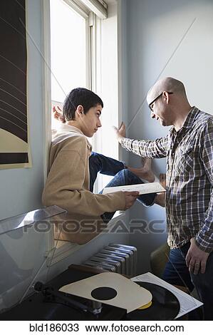 Father and son listening to records View Large Photo Image Stock Image - Father and son listening to records. Fotosearch