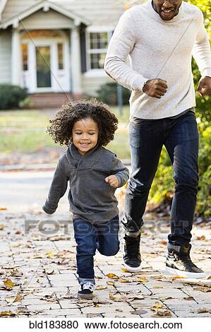 Father and son playing in driveway View Large Photo Image Stock Image - Father and son playing in driveway. Fotosearch