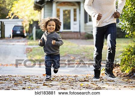 Father and son playing in driveway View Large Photo Image Stock Image - Father and son playing in driveway. Fotosearch