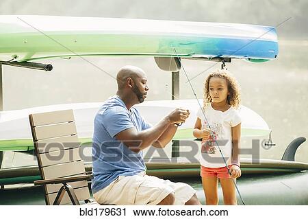 Father baiting fishing hook for daughter at lake View Large Photo Image Stock Image - Father baiting fishing hook for daughter at lake. Fotosearch