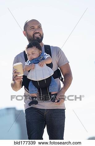 Stock Photo - Father carrying baby son outdoors. Fotosearch