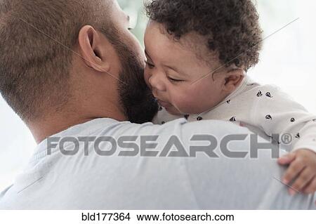 Picture - Father holding baby son. Fotosearch