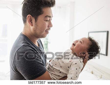 Father holding baby son View Large Photo Image Stock Photo - Father holding baby son. Fotosearch