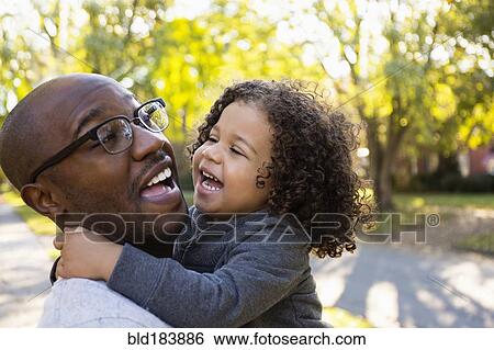Father holding son outdoors View Large Photo Image Stock Photograph - Father holding son outdoors. Fotosearch