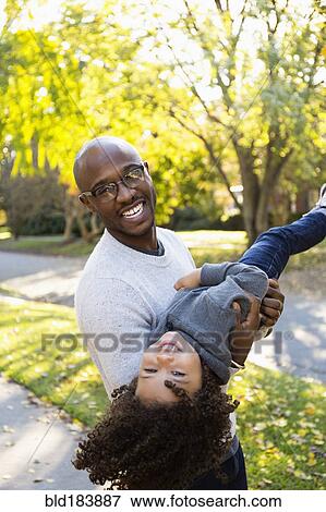 Stock Photo - Father playing with son outdoors. Fotosearch