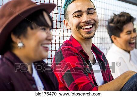 Friends laughing outdoors View Large Photo Image Stock Image - Friends laughing outdoors. Fotosearch
