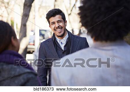 Friends laughing outdoors View Large Photo Image Stock Image - Friends laughing outdoors. Fotosearch