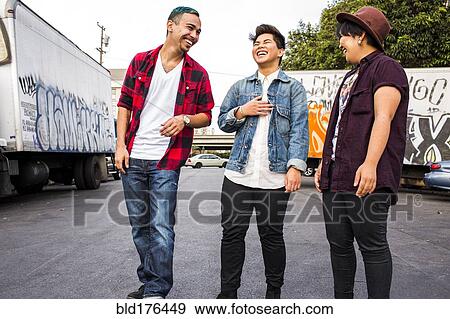 Stock Photo - Friends laughing outdoors. Fotosearch