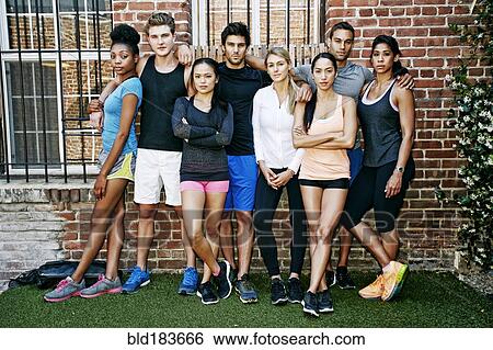Stock Photograph - Friends leaning on brick wall. Fotosearch