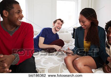Friends relaxing in bedroom View Large Photo Image Stock Image - Friends relaxing in bedroom. Fotosearch