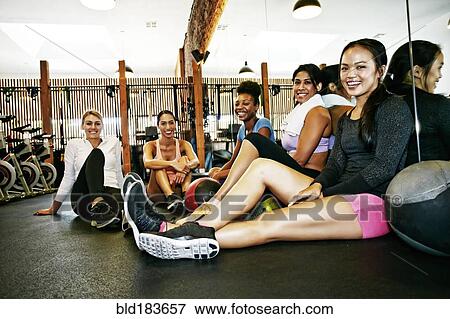 Friends smiling in gymnasium View Large Photo Image Stock Photo - Friends smiling in gymnasium. Fotosearch