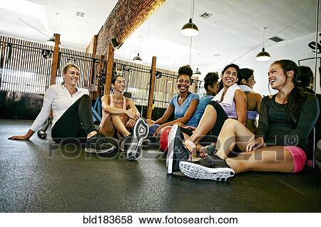Friends smiling in gymnasium View Large Photo Image Stock Photo - Friends smiling in gymnasium. Fotosearch
