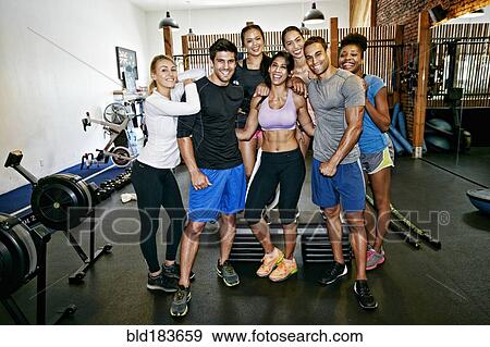 Friends smiling in gymnasium View Large Photo Image Stock Photo - Friends smiling in gymnasium. Fotosearch