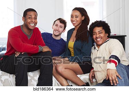 Friends smiling on bed View Large Photo Image Picture - Friends smiling on bed. Fotosearch